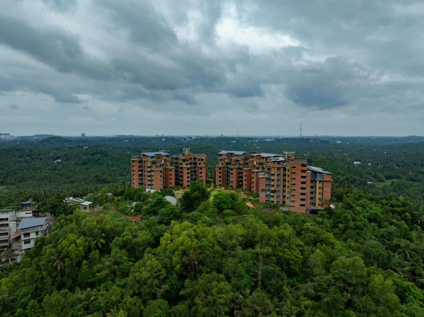 Barefoot On The Hills Calicut — villa and apartment residences nestled on hillside with lush green surroundings